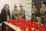 Anne-Marie with cadets attaching poppies to their Weeping Window display.