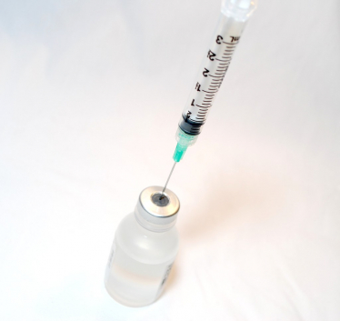 "Syringe and Vaccine" by NIAID is licensed under CC BY 2.0. To view a copy of this license, visit https://creativecommons.org/licenses/by/2.0/?ref=openverse.